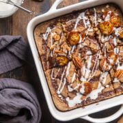 cinnamon roll baked oatmeal in a white 8x8 dish on a table.