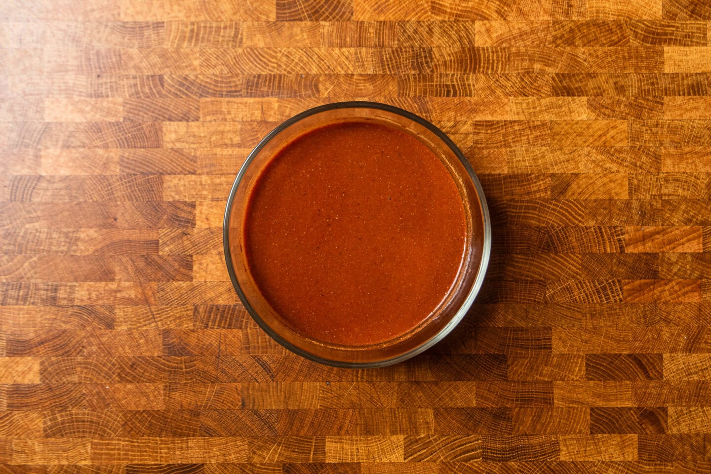apple cider bbq sauce in a glass bowl on a table.