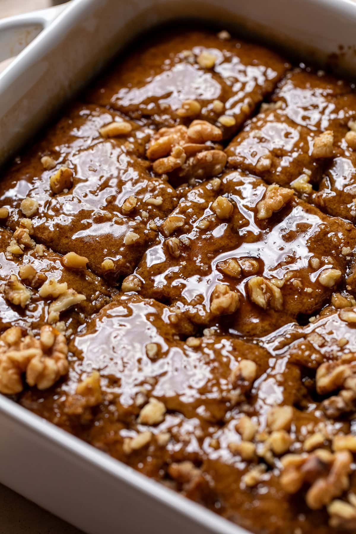 close up of vegan toffee pudding topped with walnuts.