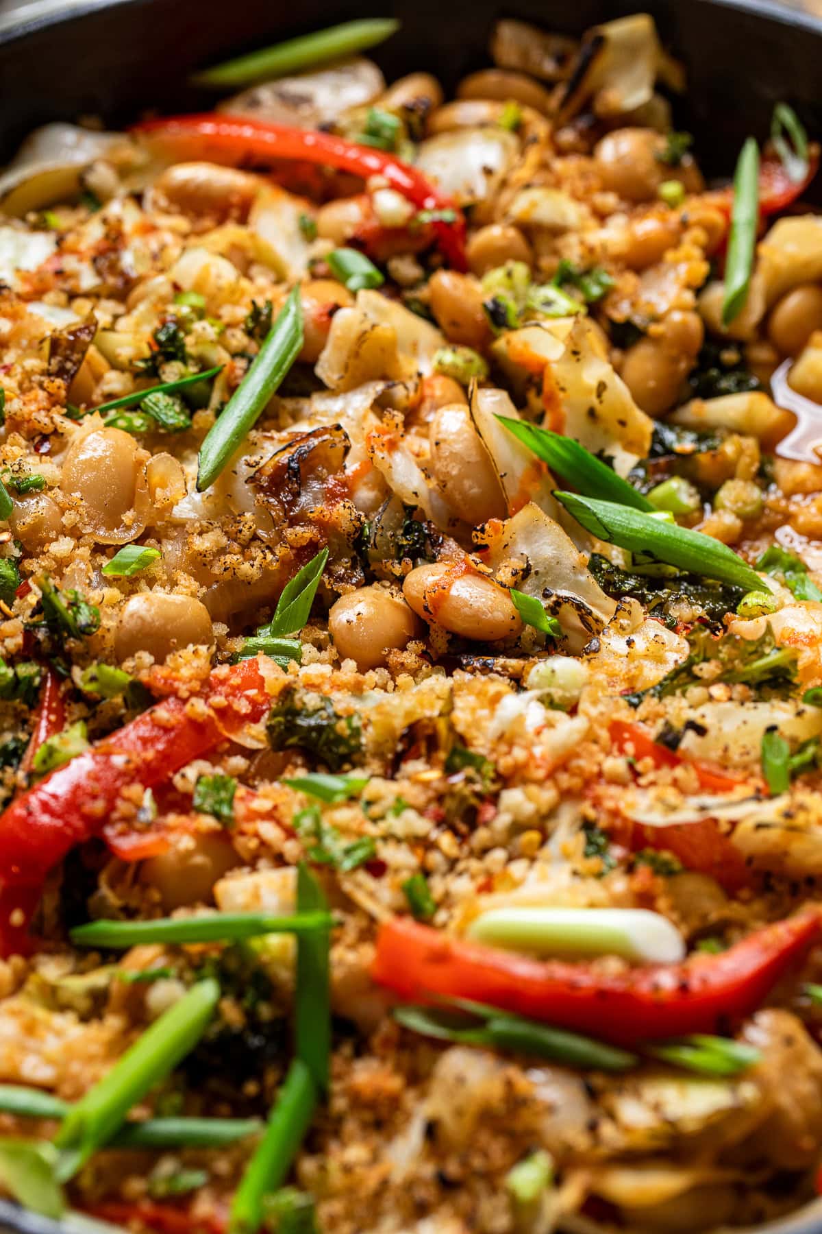 close up of hot "honey" cabbage, beans, peppers, kale, and breadcrumbs.