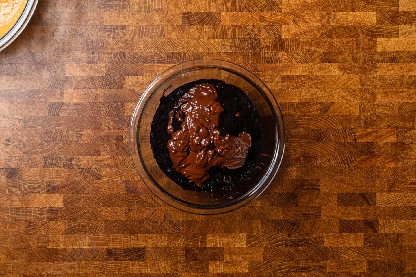 pumpkin brownie batter in a glass bowl.