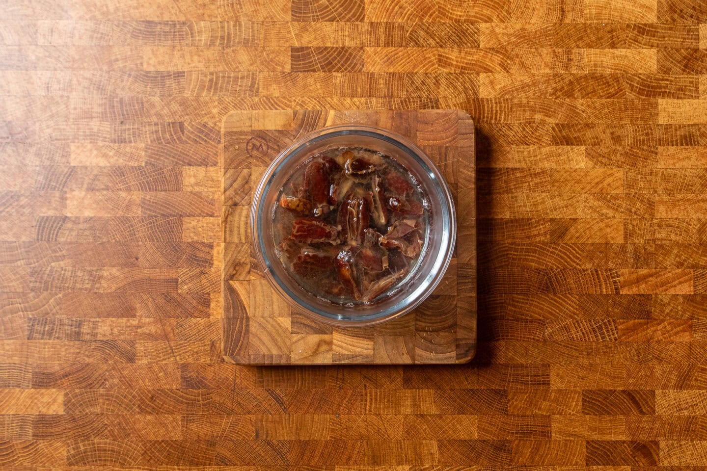 pitted dates soaking in boiling hot water.