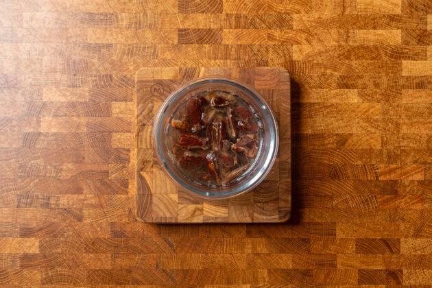 pitted dates soaking in boiling hot water.