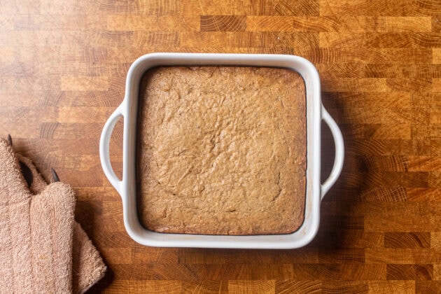 cooked toffee pudding batter on a table before spreading the toffee sauce.